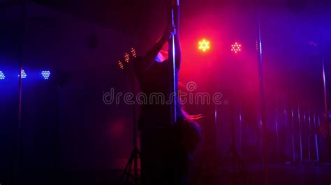 Woman With Long Flowing Hair Spinning Around A Pole In A Dark Room Stock Footage Video Of