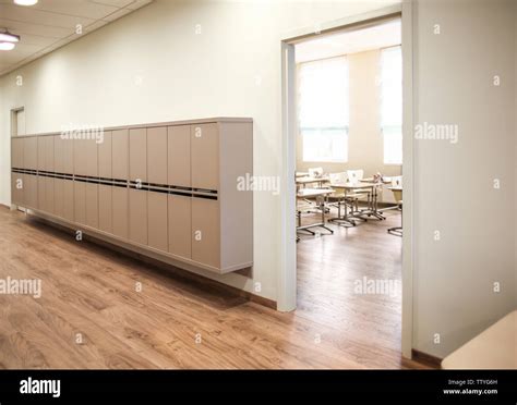 Lockers in empty school hallway Stock Photo - Alamy