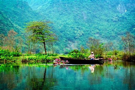 Vietnam Girl In Traditional Costume Rowing Boat For Travel Editorial