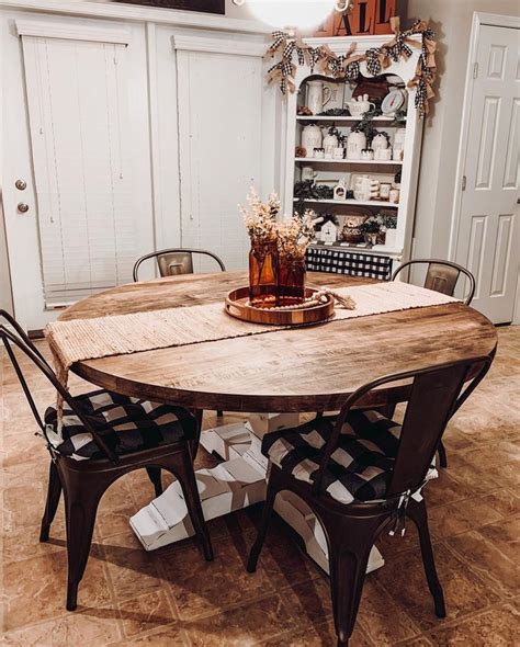 White Round Dining Table with Floral Centerpiece and Chandelier