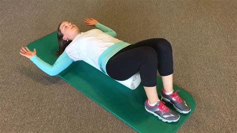 A Woman Laying On Top Of A Green Mat