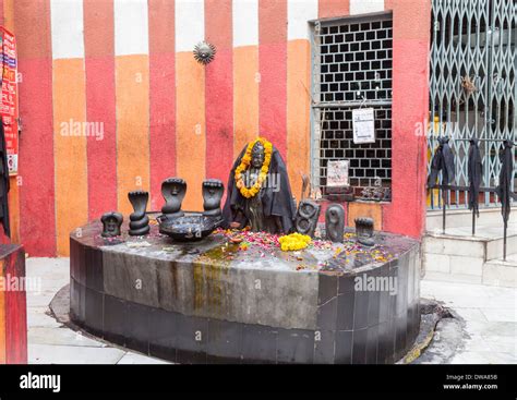 Altar In Hindu Temple In New Delhi India With Orange Marigold Garland Around Black Statue Of A