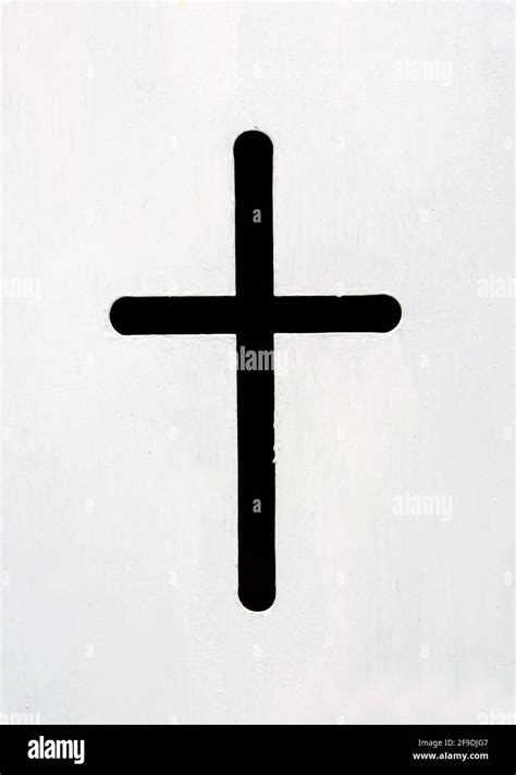 A simple black cross isolated on white background Stock Photo - Alamy