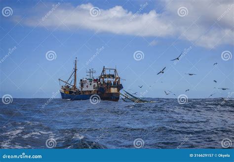 Fishing Vessel Conducts Commercial Trawling In Coastal Waters Stock