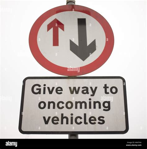 Single lane traffic, give way, UK Urban road sign Stock Photo - Alamy