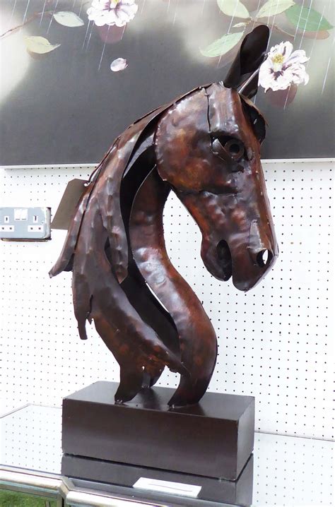 HORSE IRON SCULPTURE, in a rust finish on stand. 76cm H.