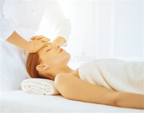 Beautiful Woman Enjoying Facial Massage With Closed Eyes In Sunny Spa Center Relaxing Treatment