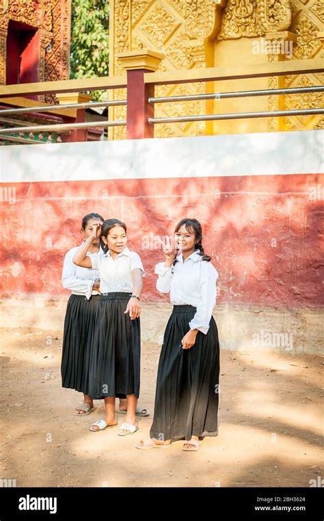 Cambodian School Girls Wait Outside Their Local School At The Floating