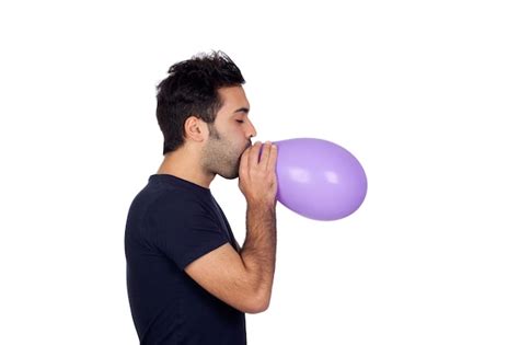 Premium Photo Attractive Young Men Swelling A Purple Balloon Isolated