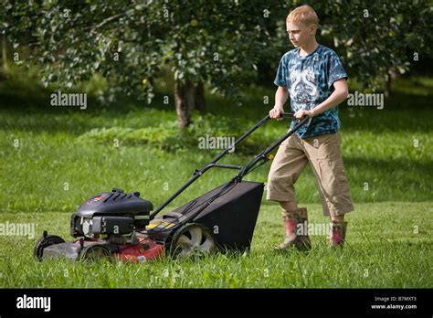 Teenage Boy Pushing Lawn Mower Stock Photo - Alamy