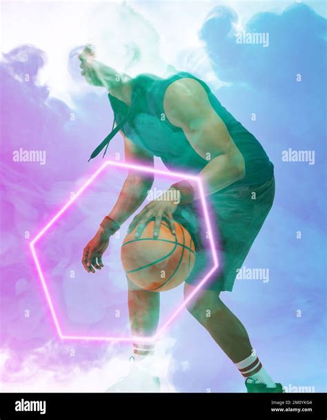 African American Male Player Dribbling Basketball By Illuminated