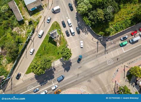 Top Down Aerial View Of Busy Street Intersection With Moving Cars