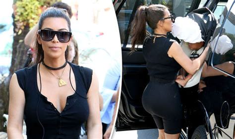 Kim Kardashian flaunts her pert derrière in SKINTIGHT shorts