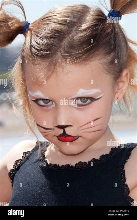 serious little girl with cat makeup Stock Photo - Alamy