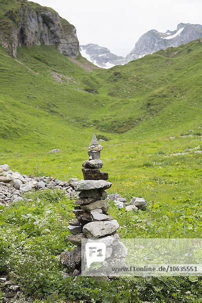 Stones Stacked On Grassy Mountain