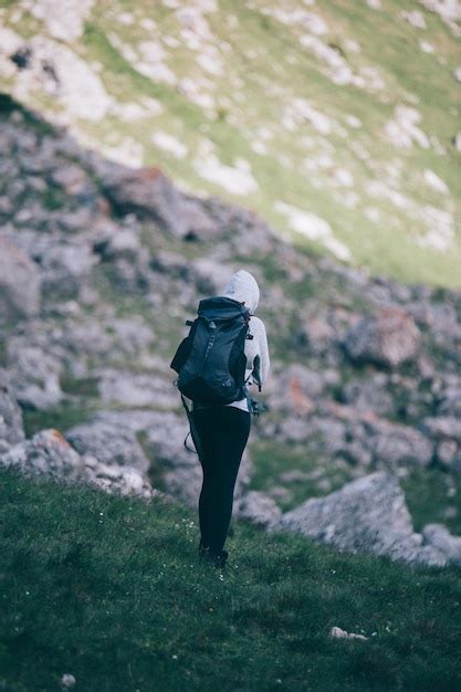 Premium Photo Rear View Full Length Of Female Hiker Walking On Mountain