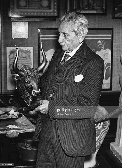 The Archaeologist Sir Arthur Evans Examines A Cretan Bulls Head At