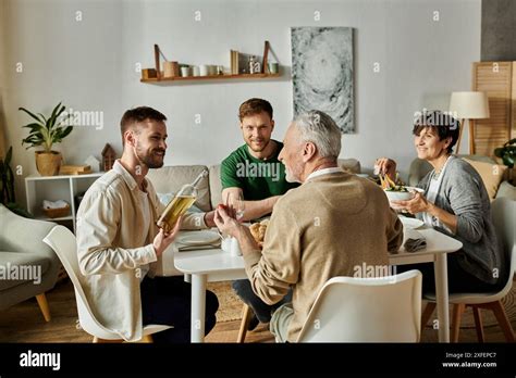 A Gay Couple Enjoys Dinner With Parents At Home Stock Photo Alamy