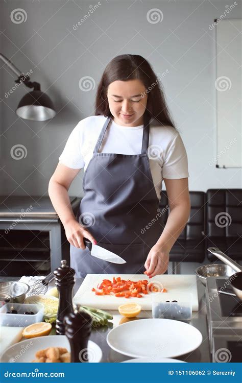 Young Woman Cooking In Restaurant Kitchen During Cooking Classes Stock