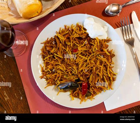 Traditional Valencian Fideua De Mariscos With Sauce Alioli Stock Photo