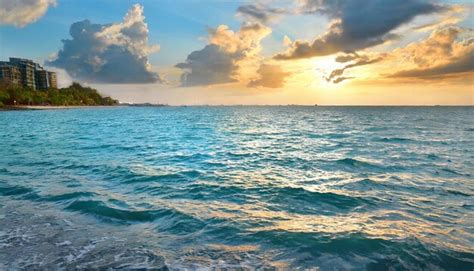 Premium AI Image | Ocean Sunset Scenery and Crystal Blue Waters