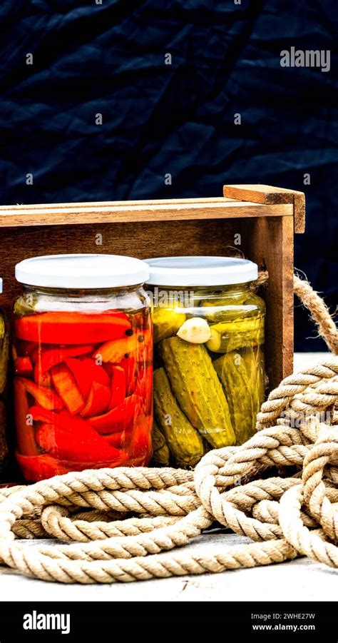 Wooden Crate With Glass Jars With Pickled Red Bell Peppers And Pickled