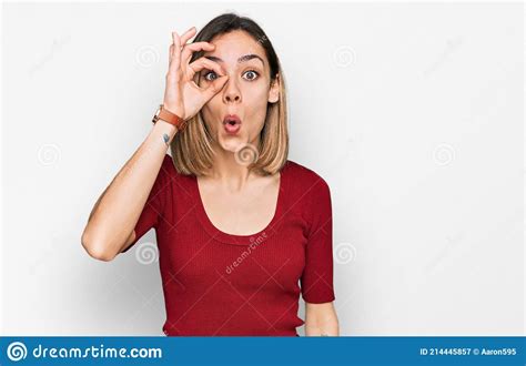 Young Blonde Girl Wearing Casual Clothes Doing Ok Gesture Shocked With