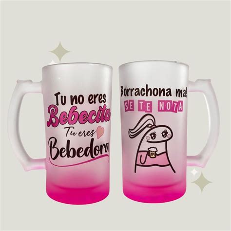 Two Glass Mugs With Pink And White Designs On Them