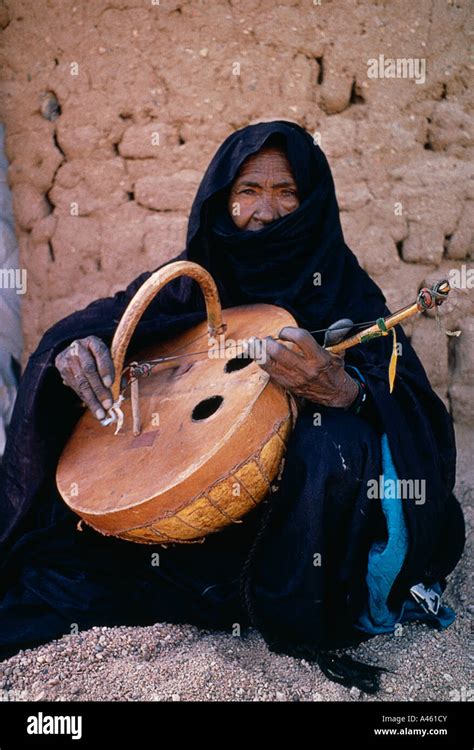 NIGER West Africa Tribal Music Tuareg woman playing an Imzad Traditional stringed instrument of ...