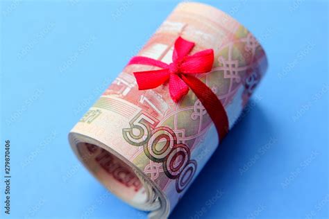 Russian money 5000 rubles twisted into a tube and tied with a ribbon ...