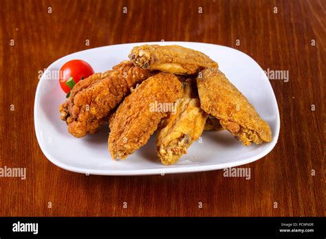 Chicken Wings Heap Served Cherry Tomato Stock Photo Alamy