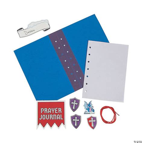 A Blue Binder With Some Stickers And Other Items Around It On A White