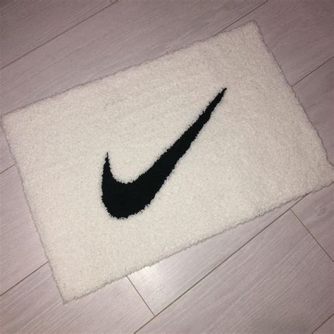 A Black And White Rug With A Nike Logo On It