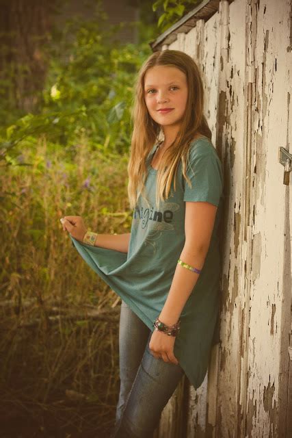 Tween Buds Tween Girl With Braids Poses In Tall Grass Stock Photo