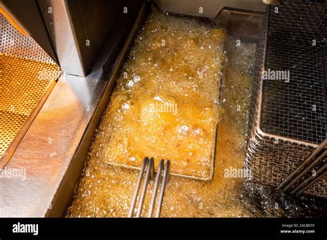 Frying Fish And Chips In Deep Fat Fryer Hi Res Stock Photography And