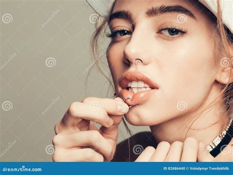 Pretty girl piercing lip stock photo. Image of jewelry - 82686440