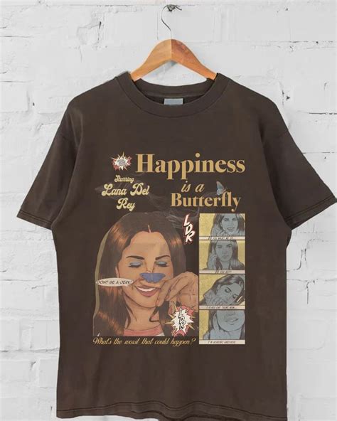 A Brown T Shirt With An Image Of A Woman Brushing Her Teeth And The