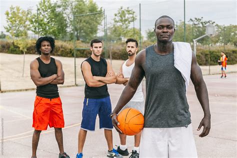 "Friends Rests After A Street Basketball Game" by Stocksy Contributor "VICTOR TORRES" - Stocksy