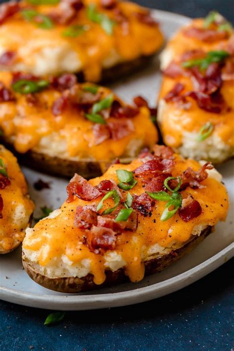 Overhead Image Of Four Twice Baked Potatoes On A White Serving Plate