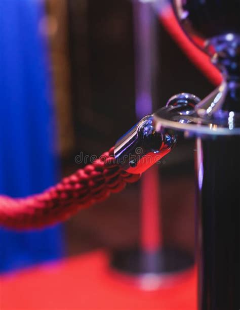 Red Carpet With Ropes And Golden Barriers On A Luxury Party Entrance