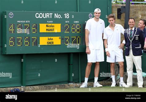 A Victorious John Isner L And Nicolas Mahut R Stand In Front Of The