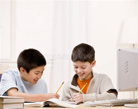 Student With Text Books Helping Friend Do Homework Stock Photo Image