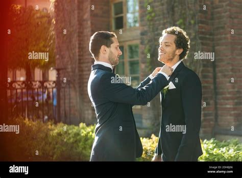 Newlywed Gay Man Adjusting Bow Tie Of Partner Stock Photo Alamy