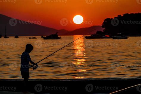 Fisherman Silhouette At Sunset Stock Photo At Vecteezy