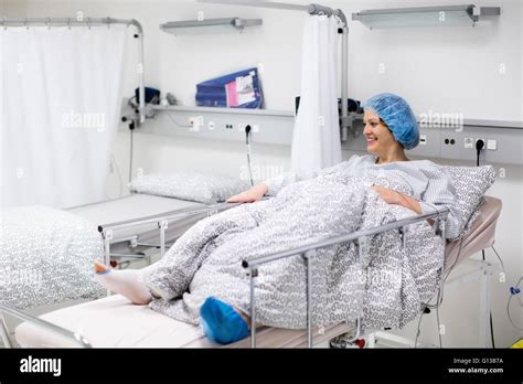 Young Patient In Scrub Cap Recovering After Surgery In Post Operative