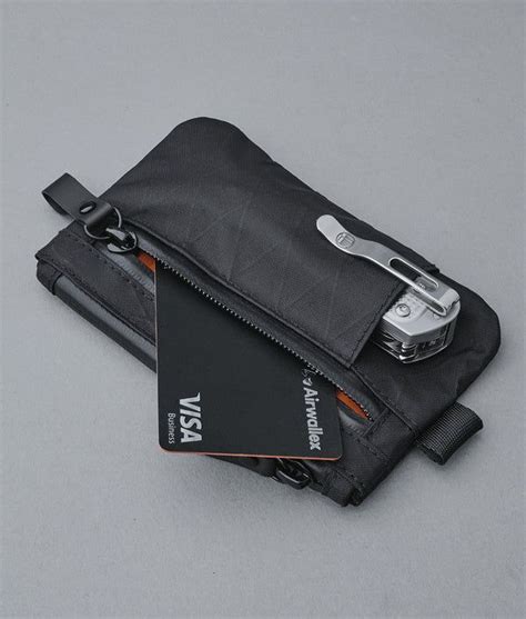 There Is A Wallet With A Credit Card In It And A Camera On The Other Side