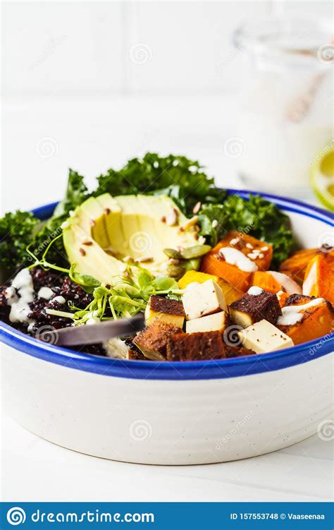 Buddha Bowl Salad with Black Rice, Avocado, Tofu, Sweet Potato, Kale and Tahini Dressing, White ...