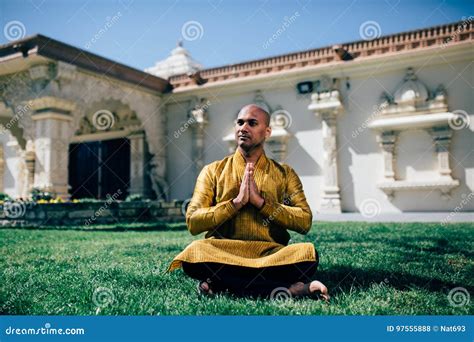 Handsom Indian Man Greeting Namaste In Gold Kurta At The Temple Stock