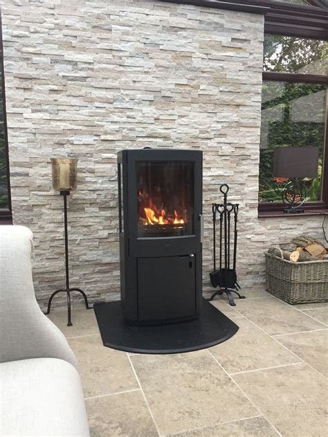 Log Burner In Conservatory With Split Faced Tiles