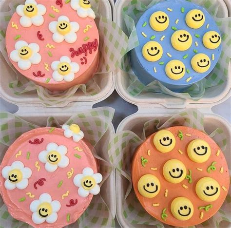 Four Decorated Cupcakes In Plastic Containers With Smiley Faces And